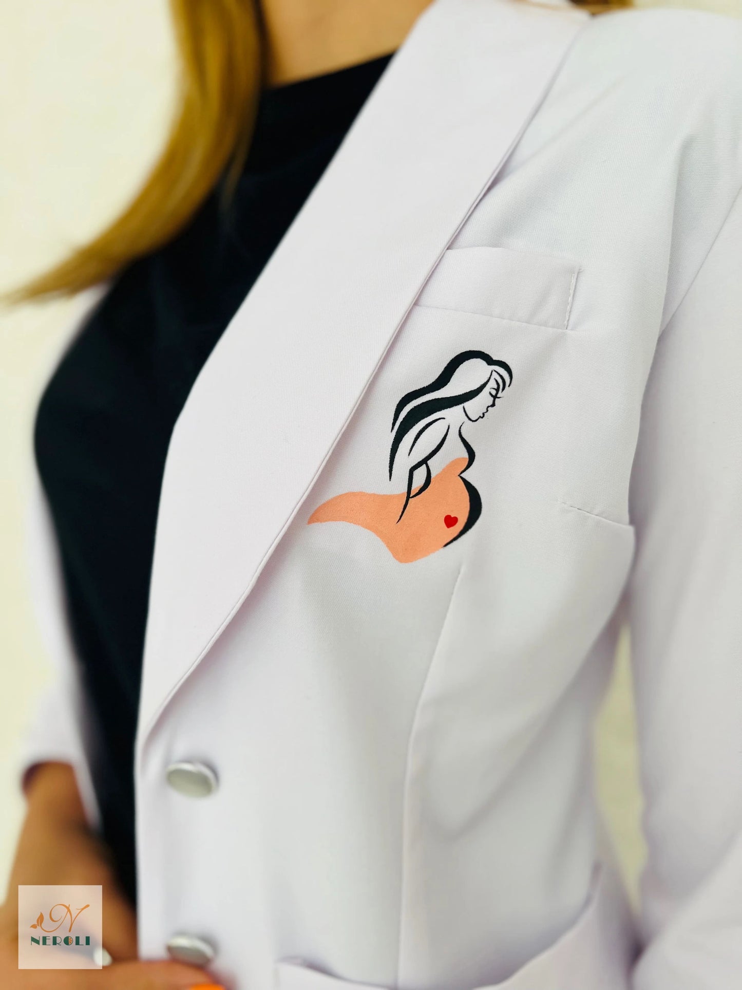 Close-up of Obstetrics and Gynaecology logo on left chest of coat - identification of women's health specialty.