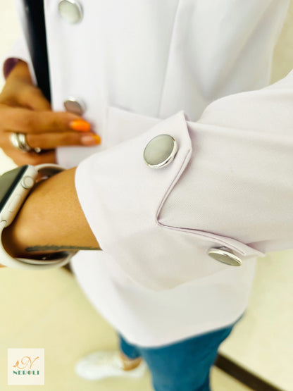 Close-up view of the folded cuff with two non-yellowing buttons on a coat