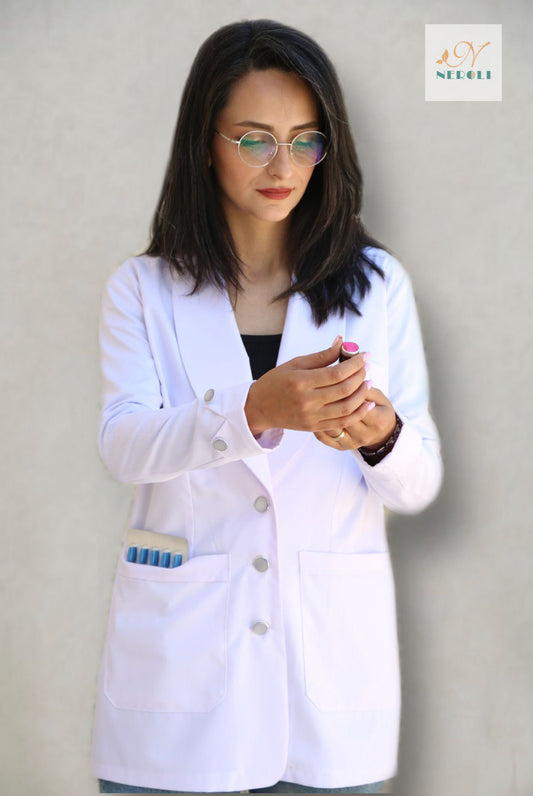 medical nurse in white coat uniform holding a clear injection bottle with focused attention.